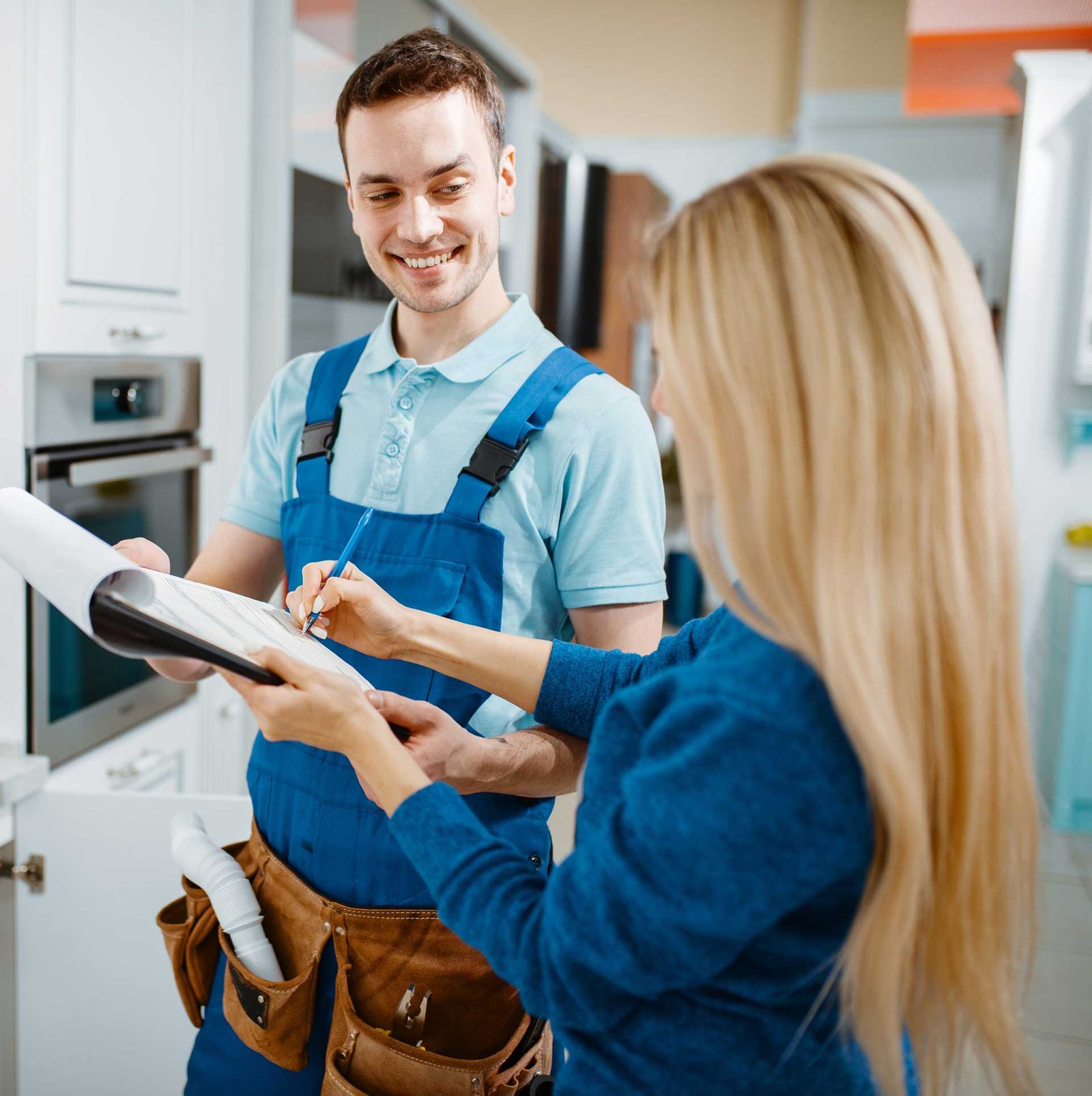 2-male-plumber-and-female-customer-in-the-kitchen-EKTSSW7.jpg