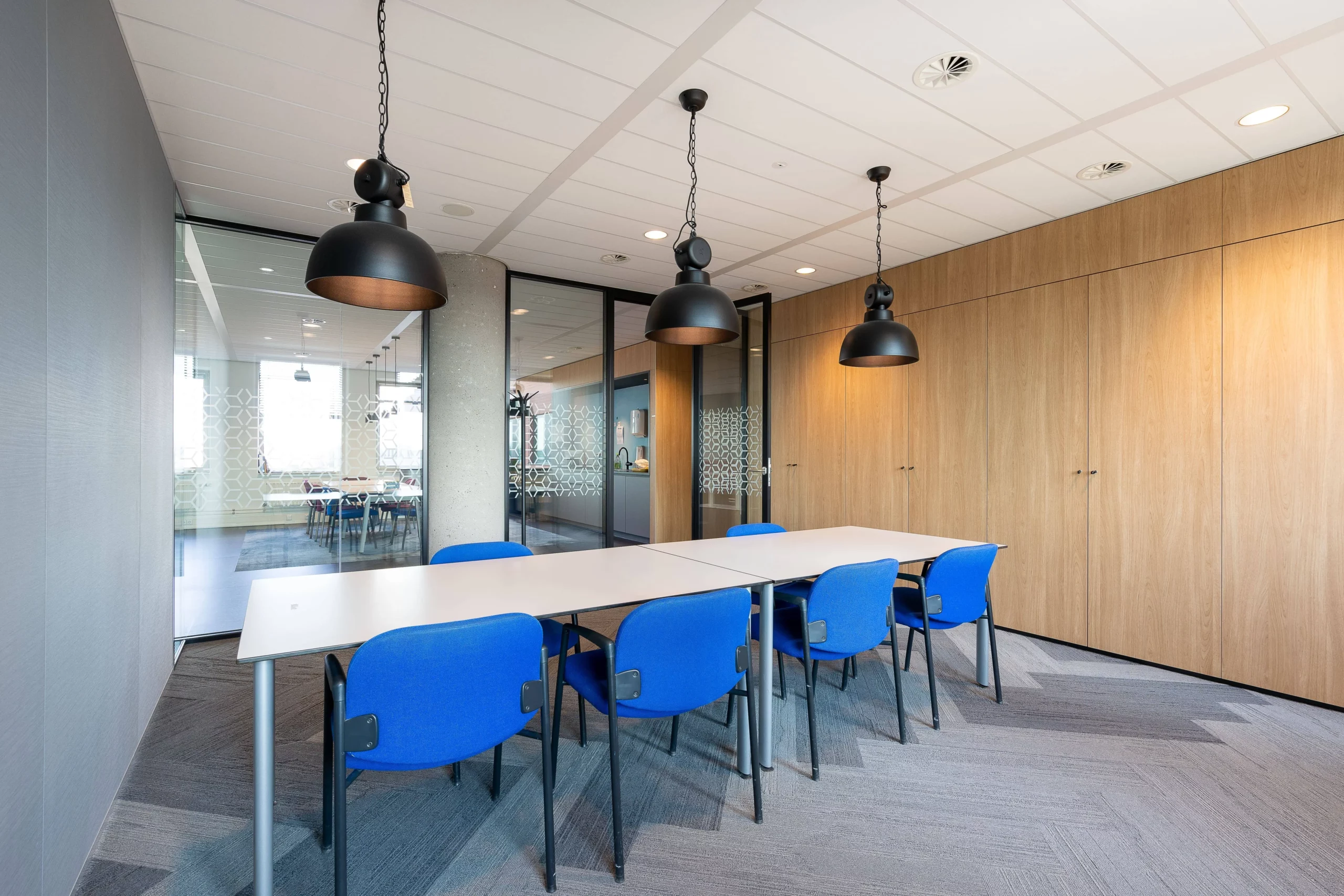 meeting-room-interior-modern-office-with-long-wooden-table-chairs-around-it-min (1)